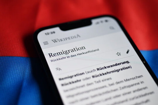 Burgdorf, Lower Saxony, Germany - January 15, 2024: A smartphone display shows the word remigration - remigration was named the bad word of the year 2024 by the German Language Society