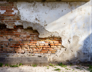 old cracked plaster and brick wall