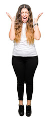 Young beautiful woman wearing casual white t-shirt celebrating mad and crazy for success with arms...