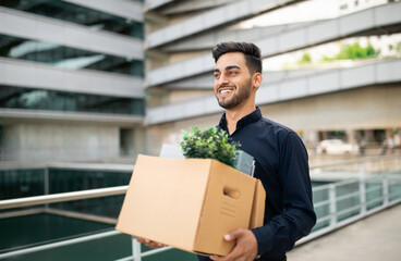 young professional arabic businessman carries belongings box reflecting optimism outdoor