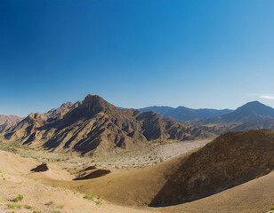 Panorama of desert mountains with blue sky and copy space