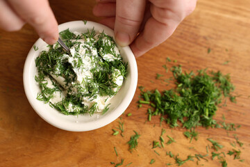 Dill is added to the cheese and mixed