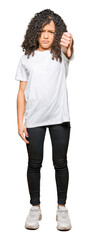 Obraz premium Young beautiful woman with curly hair wearing white t-shirt looking unhappy and angry showing rejection and negative with thumbs down gesture. Bad expression.