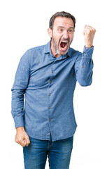 Handsome middle age elegant senior man over isolated background angry and mad raising fist frustrated and furious while shouting with anger. Rage and aggressive concept.