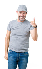 Handsome middle age hoary senior man wearing sport cap over isolated background doing happy thumbs up gesture with hand. Approving expression looking at the camera showing success.