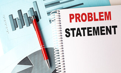 PROBLEM STATEMENT text on a notebook with pen on a chart background