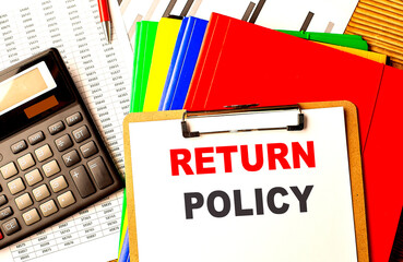 RETURN POLICY text written on paper clipboard with chart and calculator