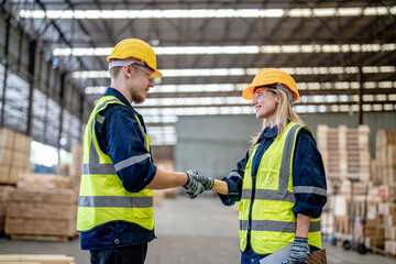workers man and woman engineering walking and handshakeing with working suite dress at warehouse....