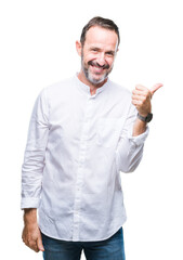 Middle age hoary senior man over isolated background smiling with happy face looking and pointing to the side with thumb up.
