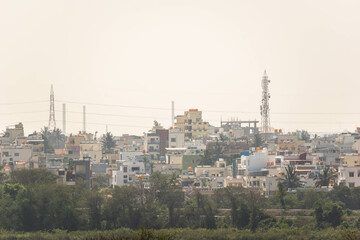 A cityscape of rooftops of low rise houses in the town of Hassan.