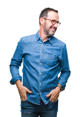 Middle age hoary senior man wearing glasses over isolated background looking away to side with smile on face, natural expression. Laughing confident.