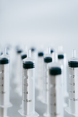 Group of syringes arranged neatly after manufacturing and arranged in orderly rows for distribution...
