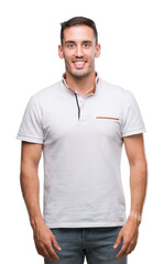 Fototapeta premium Handsome young casual man wearing white t-shirt with a happy face standing and smiling with a confident smile showing teeth