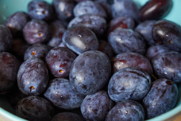 Lots of prunes in a bowl close-up in a home setting.
