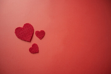 Small hearts on a red background with plenty of copy space.