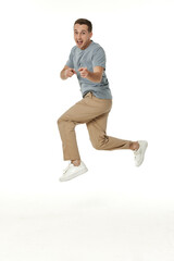 Fototapeta premium happy guy looking pointing at the camera on white studio background