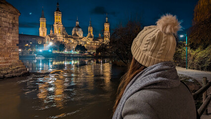Under Zaragoza's Spell: A young lady, facing away, revels in luminous reflections of Basilica del...