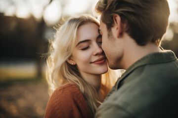 Naklejka premium Serene moment of affection as a young couple embrace, their love illuminated by the warm glow of the sunset's golden hour