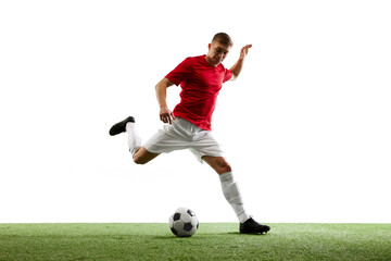 Fototapeta premium Precision in Motion. skilled football player delivers perfect airborne pass, showcasing unparalleled precision against white background with lush green grass. Concept of sport, world cup season, match