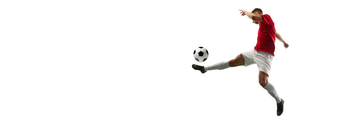 Precision in Flight. Football player kicks ball into air, creating visual masterpiece against white...