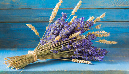 bouquet of dried lavender flowers and spikelet; blue wooden background