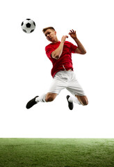 Fototapeta premium Sculpting victory in air. True artist on soccer field, footballer executes perfect pass against white background with green field. Concept of sport games, hobby, energy, world cup season, movement. Ad