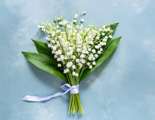 Lily of the valley flowers bouquet on pastel blue background. Womens day, Valentines day card. Top view with copy space. Flat lay