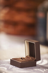 rings in the box. Close up of wedding rings in a light brown box on the table - selective focus, copy space.