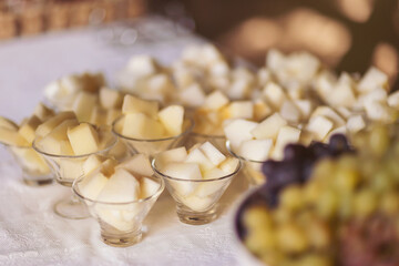 Melon slicing at the wedding buffet. Delicious sweet fruit beautifully sliced and lying on the dish. Healthy food and tasty fruit. stylish luxury catering for party, decor table of fruits.