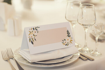 white blank space card, for Name place, Folded, greeting, invitation on wedding table setting background. with clipping path