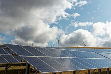 Photovoltaic system and a wind farm. Solar and Wind power are the use of solar and wind for electrical power. Popular sustainable, renewable energy for enviromental energy batteries generated megawatt