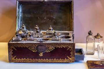 Selective focus on glass bottles inside a vintage, ornamented and keyed old medicine transportation...