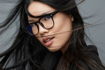 Fototapeta premium Woman glasses background studio asian student cute portrait beautiful business smile fashion face