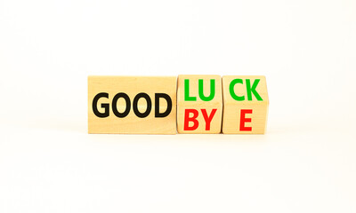 Good luck or goodbye symbol. Concept words Good luck or Goodbye on beautiful wooden blocks. Beautiful white table white background. Business, motivational good luck concept. Copy space.