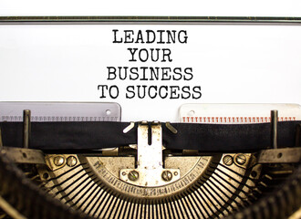 Leading your business to success symbol. Concept words Leading your business to success typed on old retro typewriter. Beautiful white background. Leading your business to success concept. Copy space