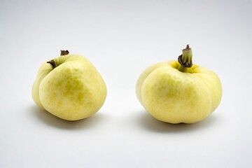 Two Fresh Rare Yellow Fruits with Green Spots, Isolated on a White Background