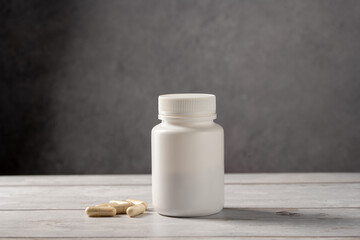 Antibiotics pills in white plastic bottle. Capsules, collagen, vitamins, pain killers or drugs