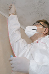 The hands of a scientist in medical white gloves put mold into a test tube. Observing and...