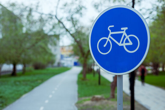 a blue road sign with a picture of a bicycle