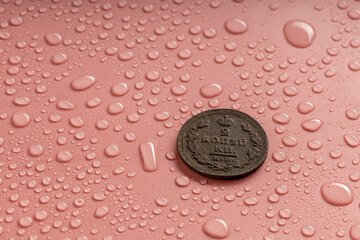 coin 2 kopecks of the old Russian Empire of the 19th century and water drops with highlights on the drops - obrazy, fototapety, plakaty