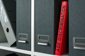 Office shelf with folders and age discrimination law.