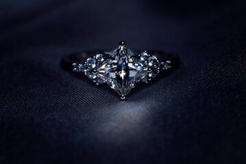 Diamond ring, princess cut, square shape on dark background