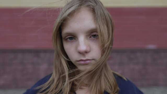 Sad teen girl near the wall