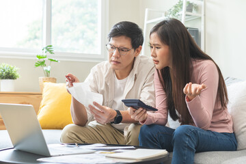 Stressed financial owe asian young couple love sitting suffer, stressed and confused by calculate expense from credit card bill, no money to pay, mortgage or loan. Debt, bankrupt or bankruptcy people.