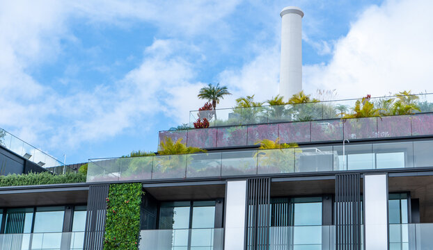 Green building design with large green walls and outdoor urban balcony.