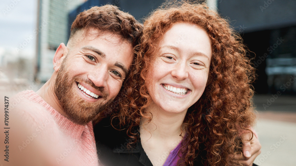 Wall mural Happy ginger hair brother and sister having fun taking selfie picture outdoor. Travel vacation concept