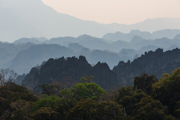 Silhouettes of limestone rocky hills at sunset. Laos