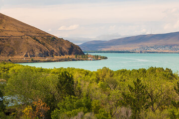 View of the biggest lake in Armenia, Sevan Lake. Mountain around. - 709986551