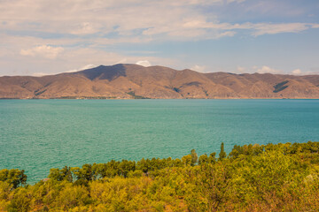 View of the biggest lake in Armenia, Sevan Lake. Mountain around. - 709986964