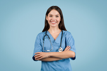Smiling nurse with arms crossed, blue background